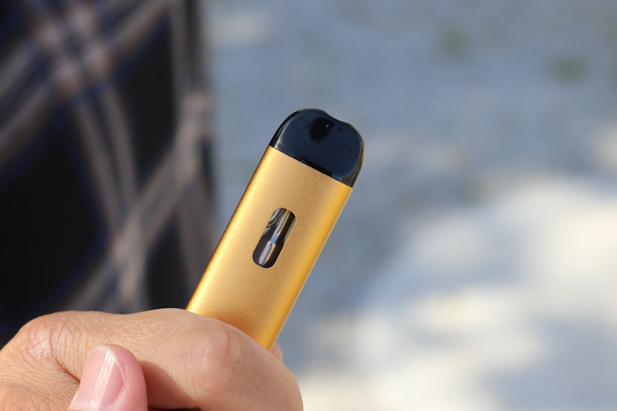 a person holding a yellow device